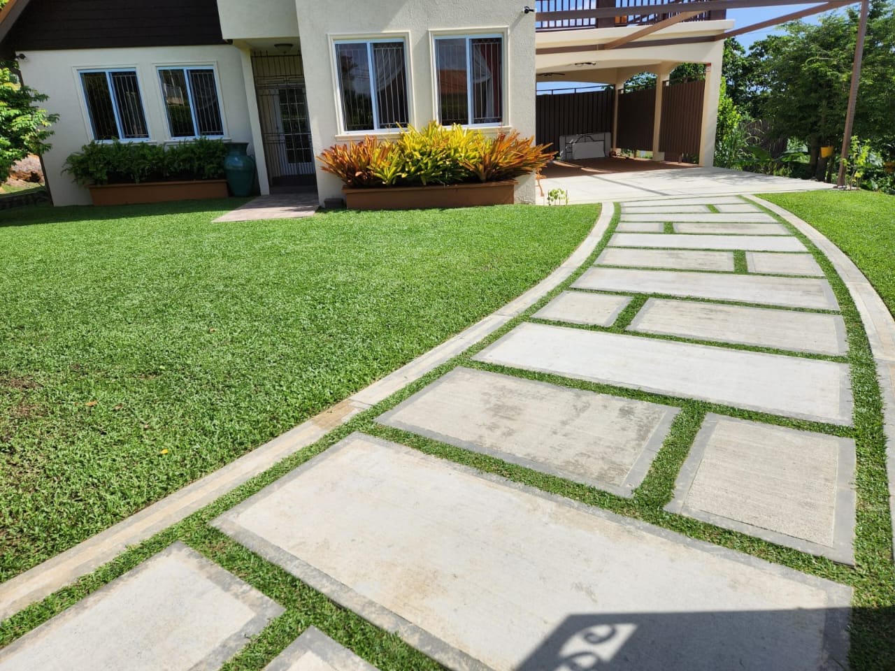 Cap Estate residential landscaping project in Saint Lucia with stone hardscaping walkway designed and maintained by Turf Pro Landscaping.
